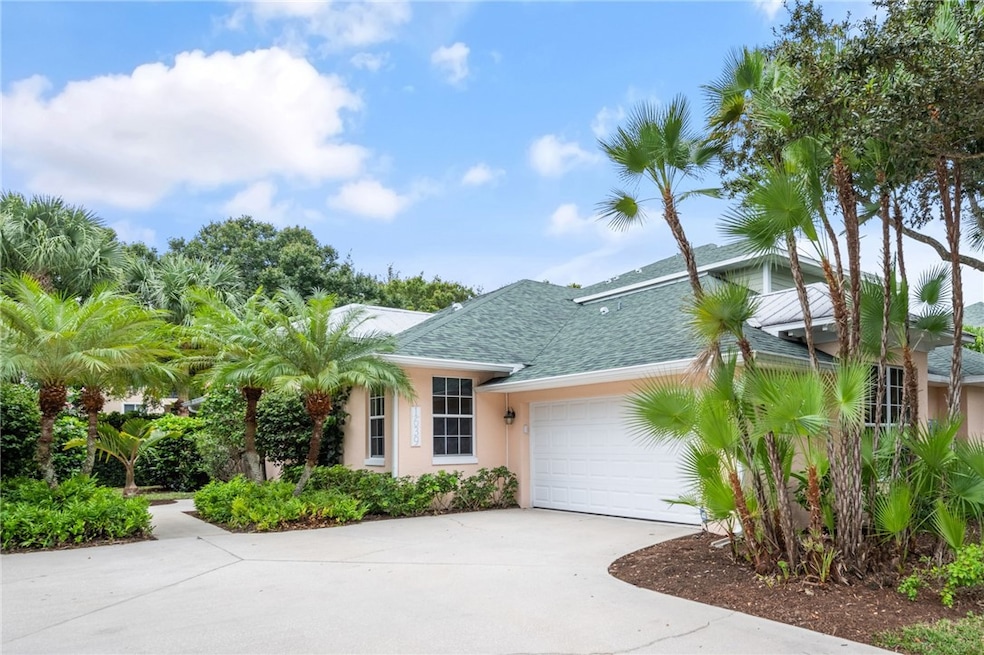 View of front of property with a shingled roof, driveway, stucco siding, and a garage