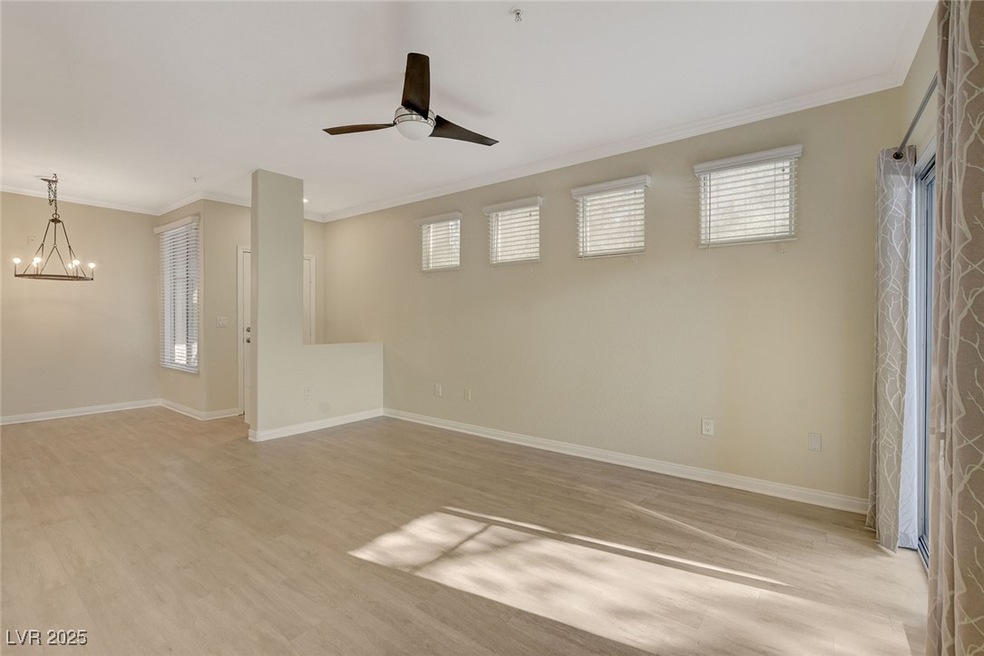 Living room with ceiling fan, crown molding, luxur