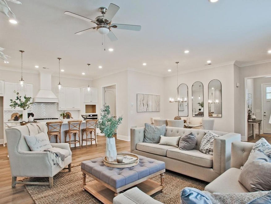 Living room featuring ornamental molding, light ha