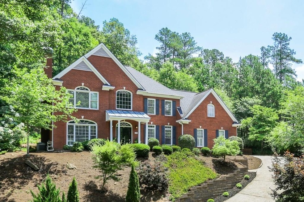 Beautiful 3 sided brick home with charming portico