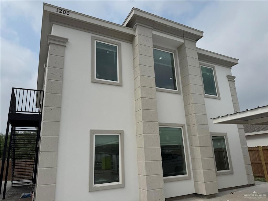 View of home's exterior with stairway and stucco siding