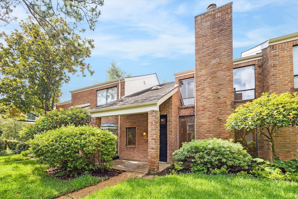 Charming brick exterior with mature landscaping we