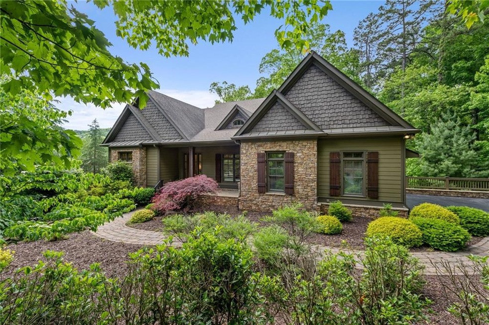 Craftsman house with stone siding and fence