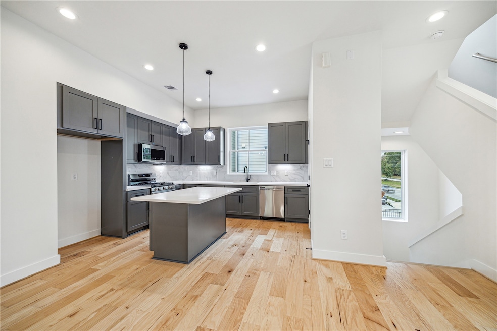 This modern kitchen features sleek gray cabinets,