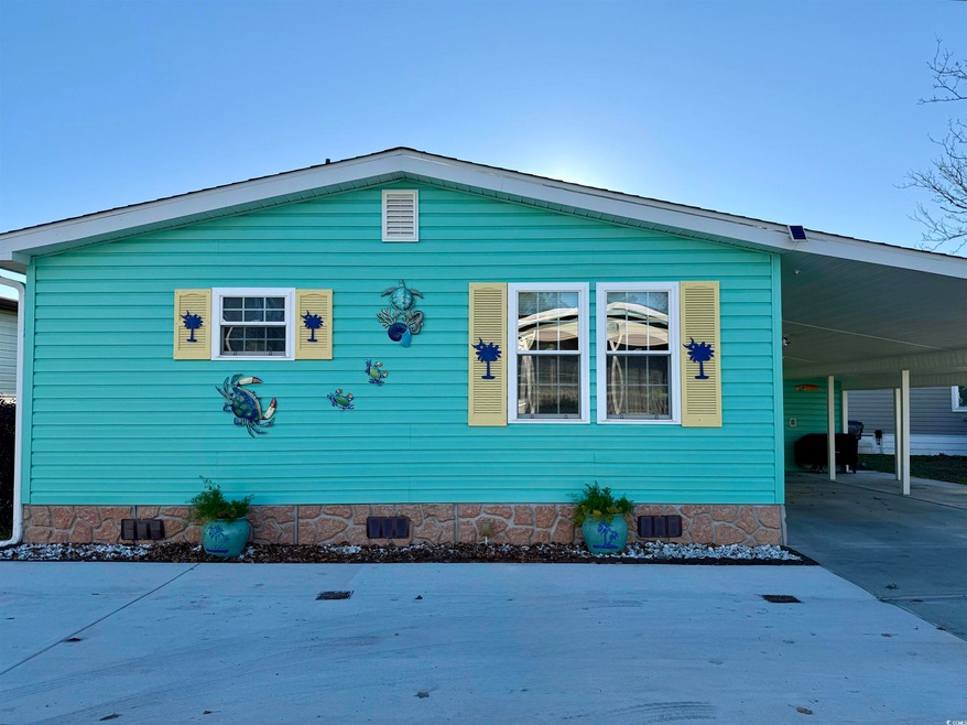 View of side of property with a carport