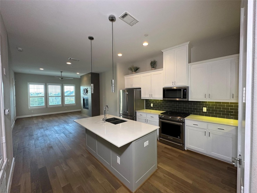 Kitchen with dark wood-type flooring, white cabine