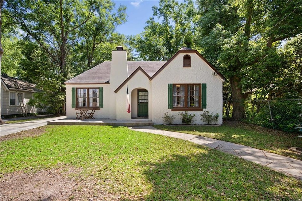 Tudor-style house with stucco siding, a front lawn