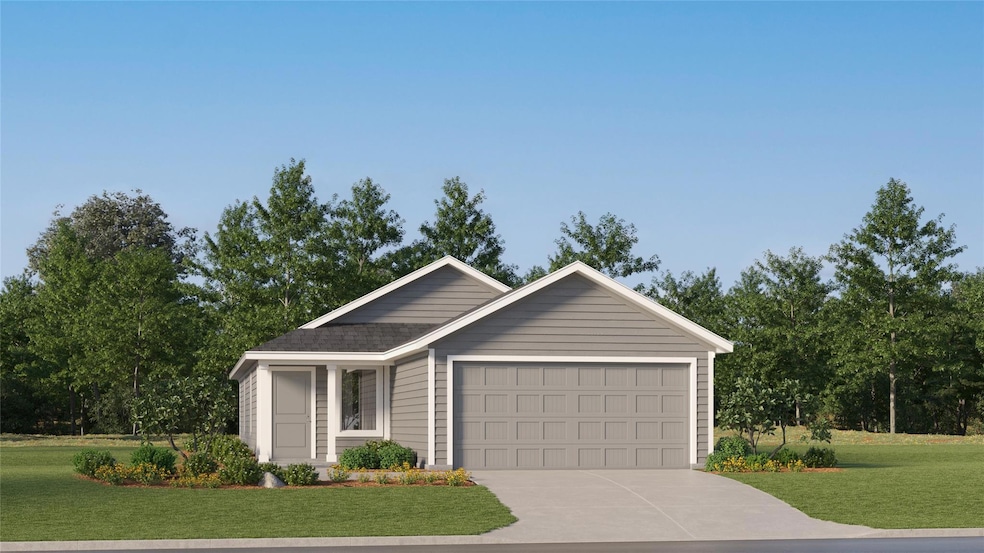 Ranch-style house featuring a garage and a front lawn