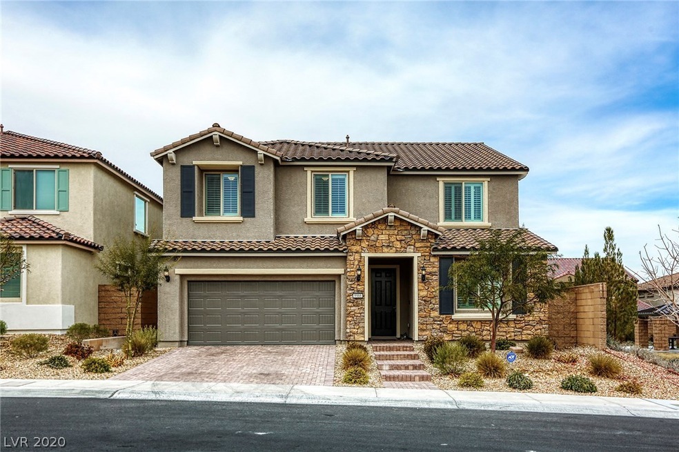 Front elevation featuring stone veneer and paver d