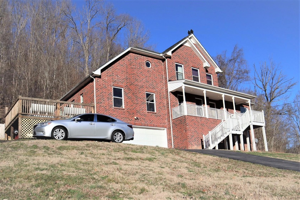 Beautiful brick home with a 2 car garage, full unfinished basement, deck with a view plus a rocking chair front porch! Love this home!