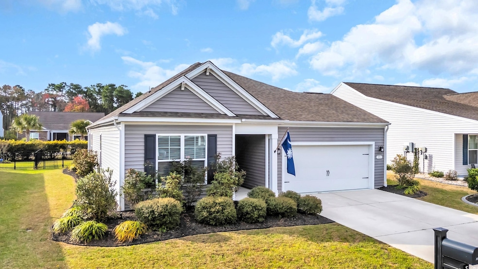 View of front of home with a front yard, concrete 