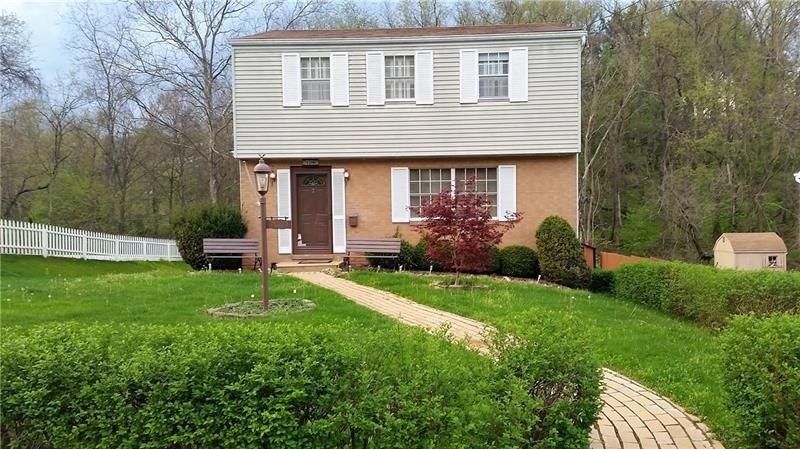 Front of home with Red Maple tree, welcoming bench