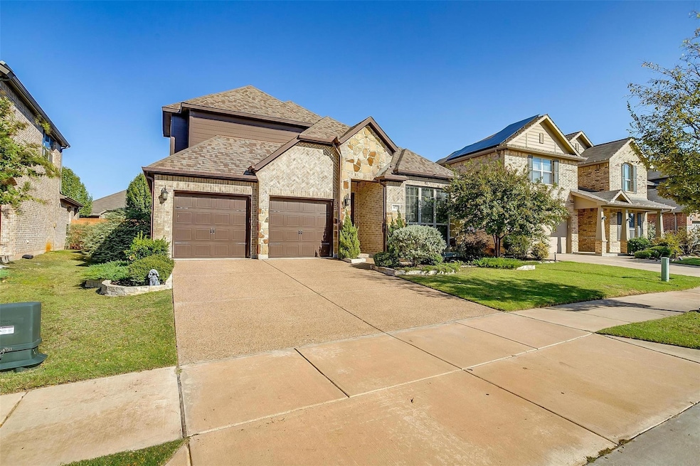 View of front of property featuring a front yard and a garage