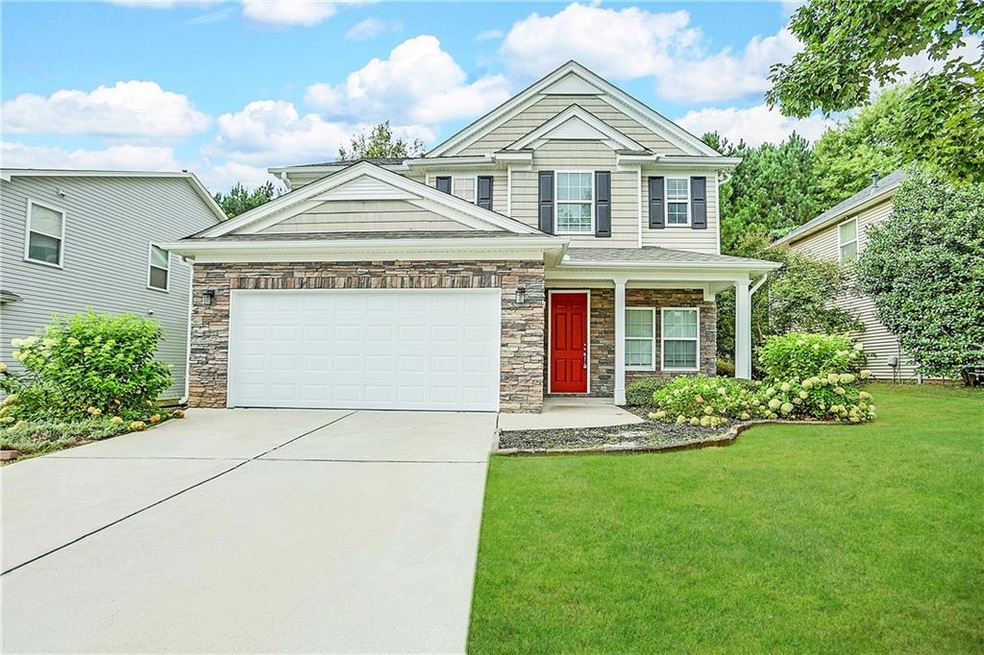 View of front of property with a garage and a front lawn