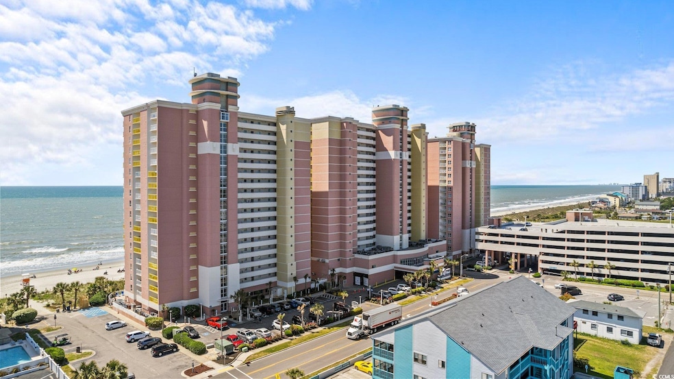 View of building exterior with a water view and a beach view