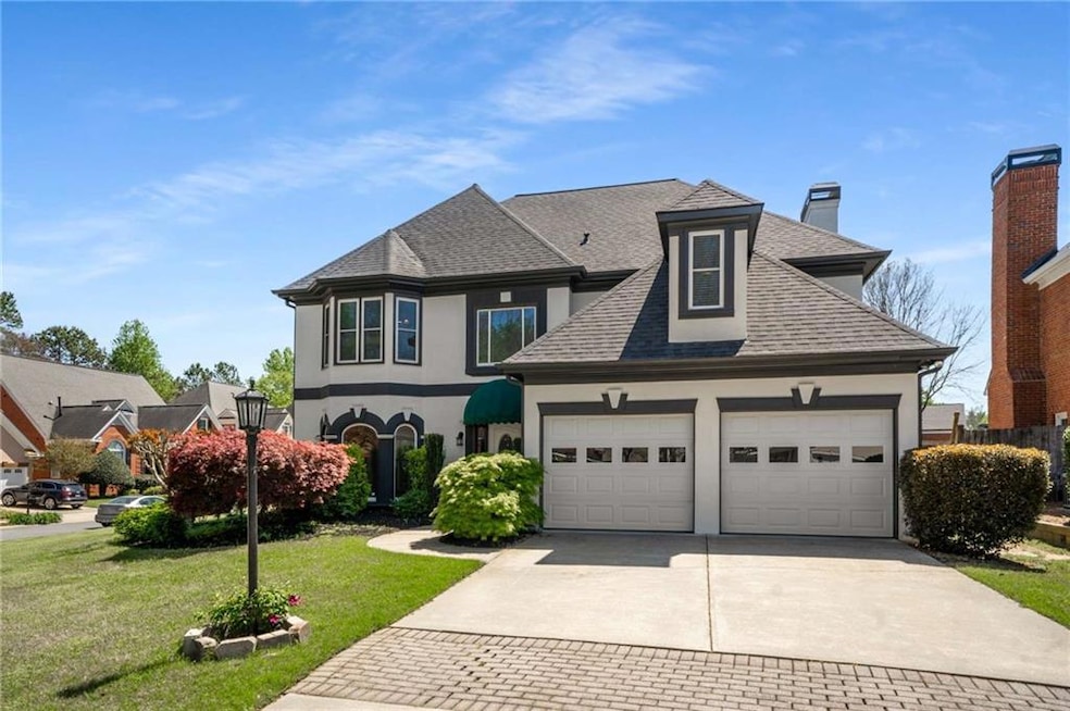 View of front of property featuring a garage, stuc