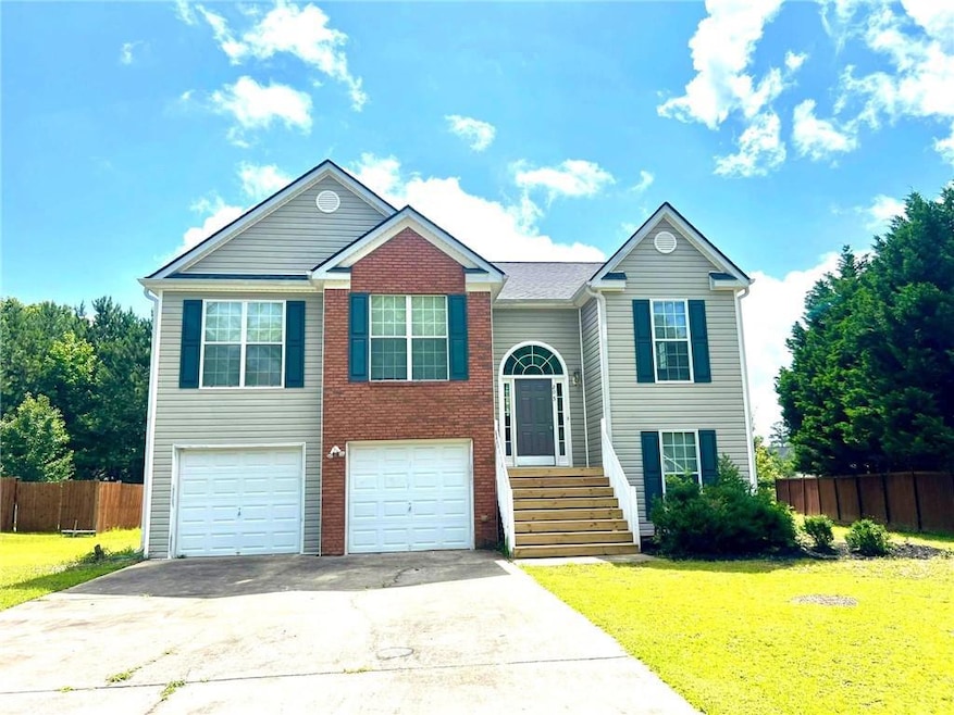 View of front of home with driveway, an attached garage, and brick siding