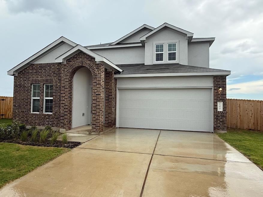 Traditional home with brick siding, driveway, an 