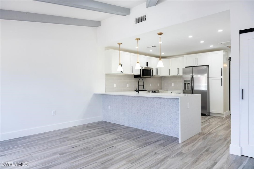 Kitchen featuring tasteful backsplash, stainless s