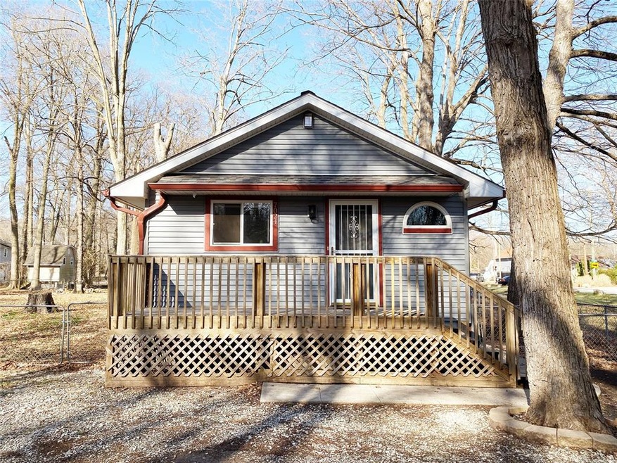 Updated bungalow on large fenced, wooded lot.
