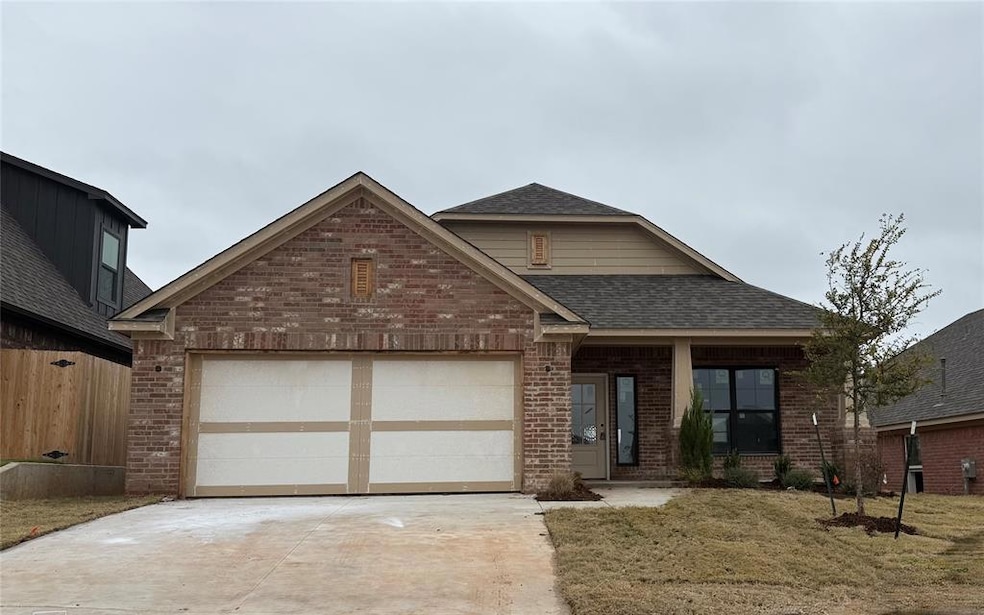 View of front of home featuring brick siding, roof with shingles, driveway, an attached garage, and covered porch