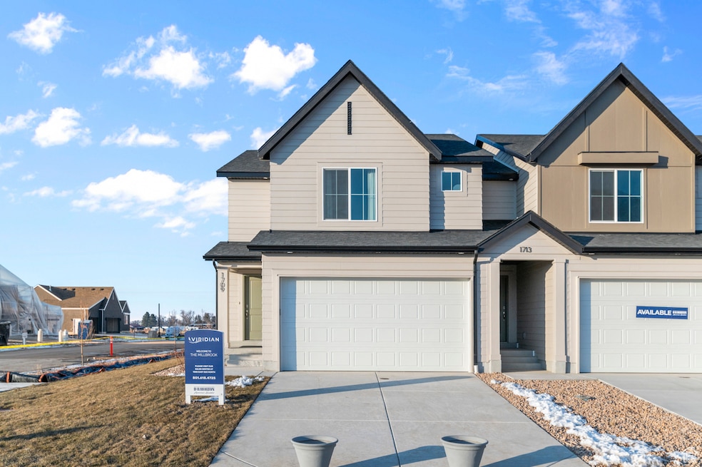 View of front of home featuring driveway, a shingled roof, a garage, and board and batten siding