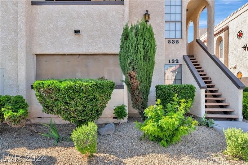 View of side of property with stucco siding and st