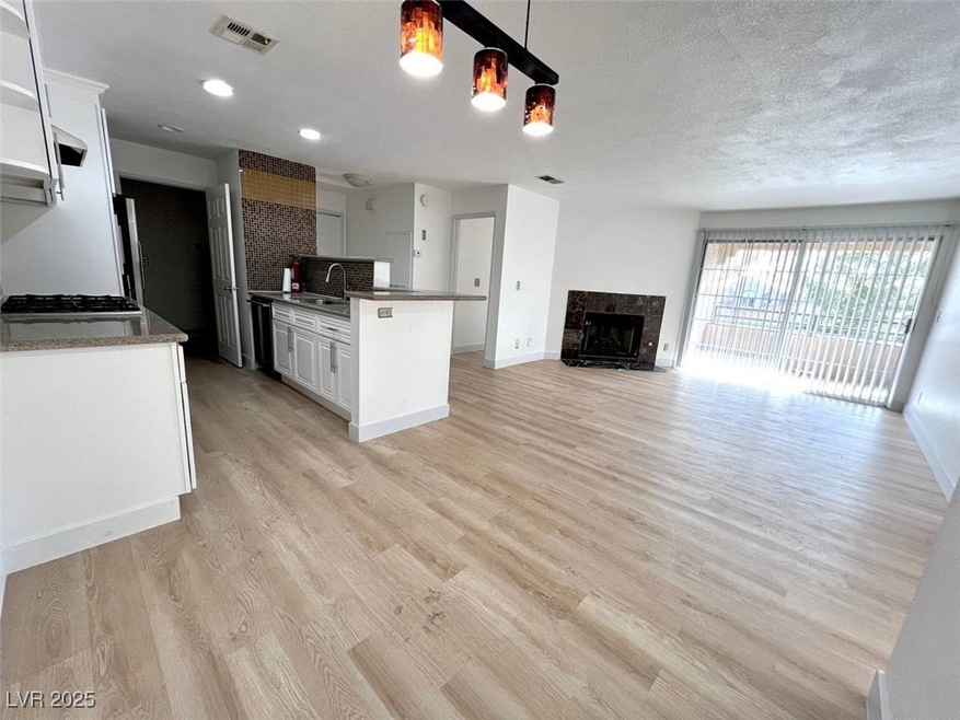 Dining and living room with baseboards, light wood