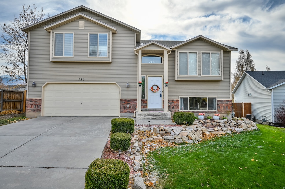 View of front of home featuring brick siding, driveway, and a garage