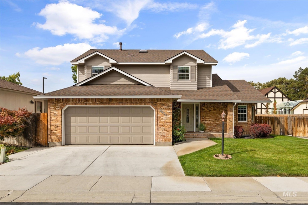 Traditional home featuring covered porch, a shingled roof, brick siding, concrete driveway, and a garage