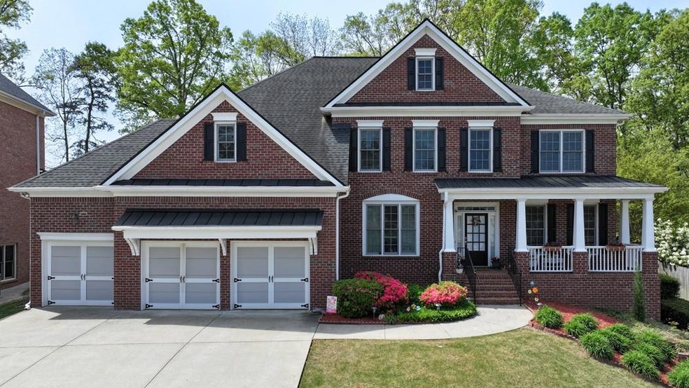 View of front facade with concrete driveway, an at