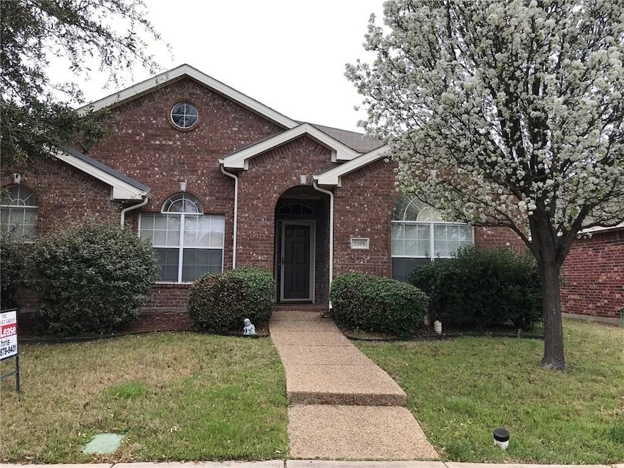View of front of home with a front lawn and brick siding