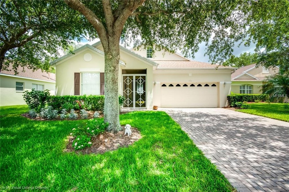Screened in entrance, paver driveway and great cur
