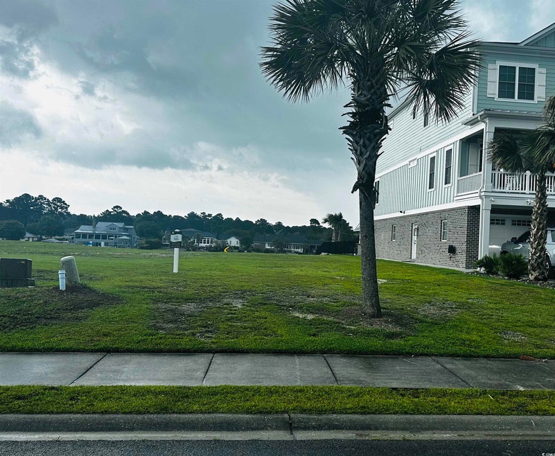 View of property's community with a yard and an attached garage