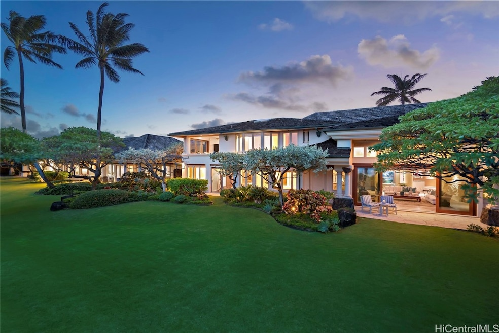 An emerald expanse of lawn opens up to a white san