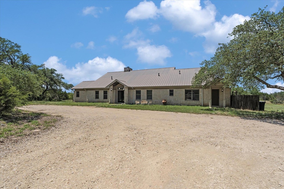 View of front facade featuring dirt driveway, a c