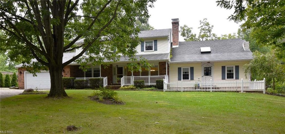 View of front of property featuring garage, a porc