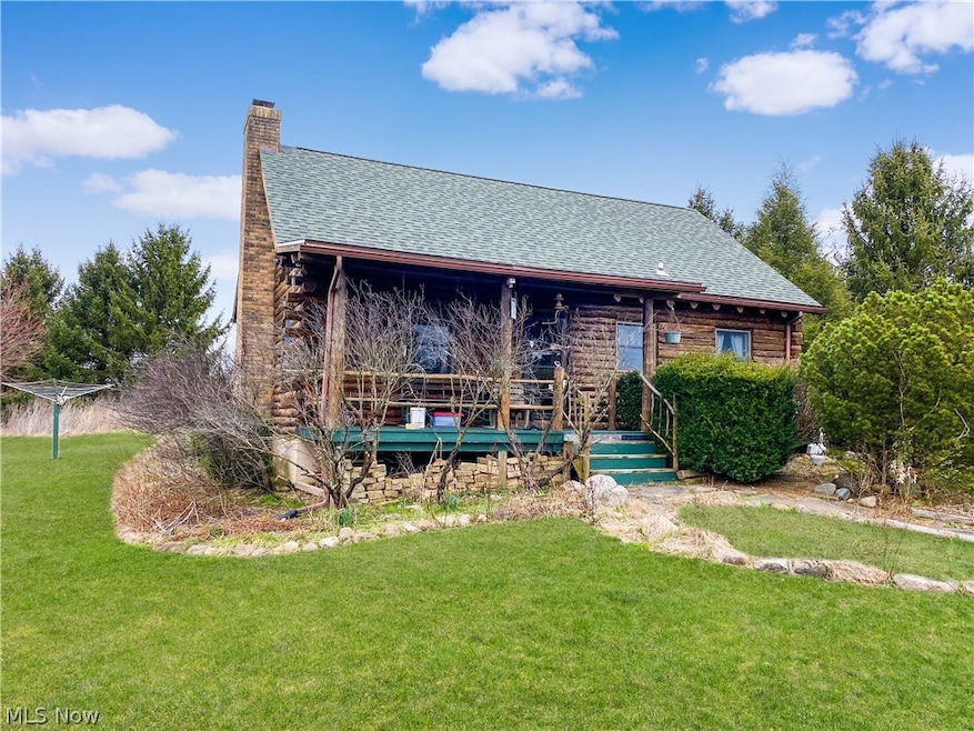 Rear view of property featuring a lawn