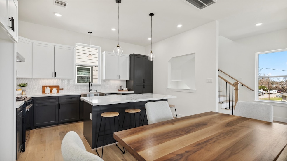 This modern kitchen features sleek black and white