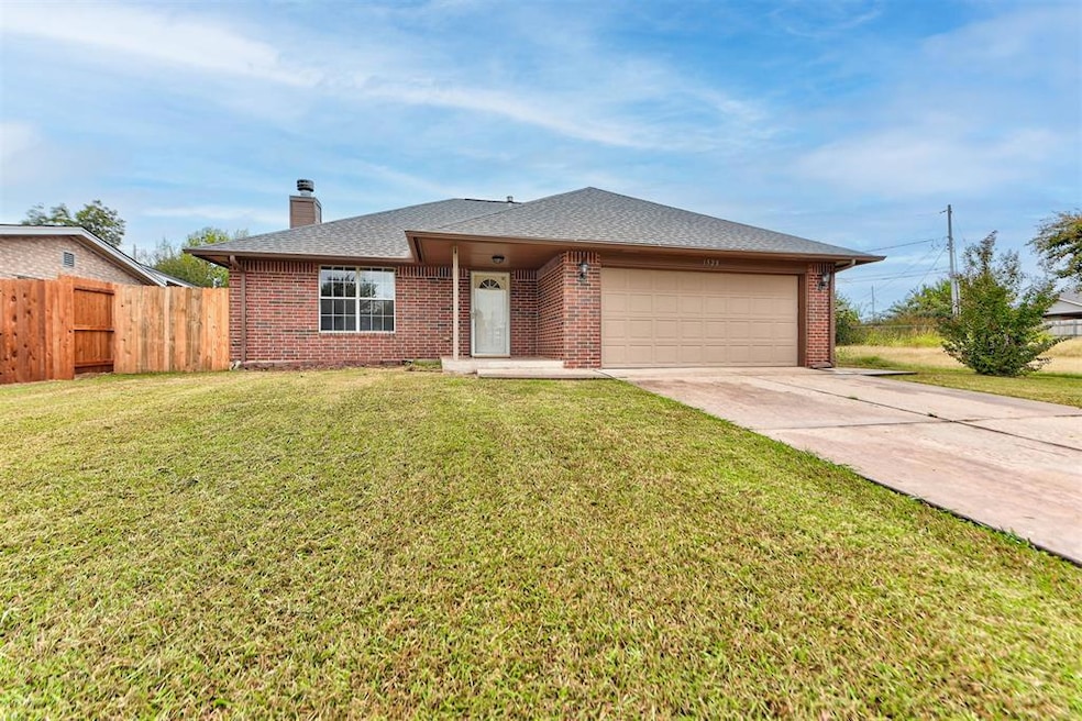 Ranch-style house with driveway, a shingled roof, brick siding, and a chimney