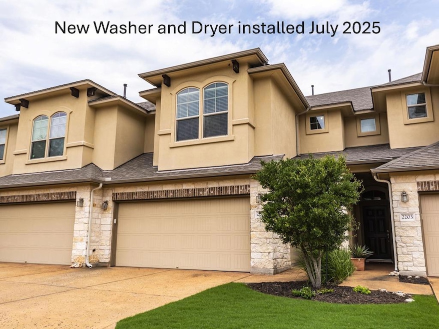 View of property featuring stone siding, stucco s