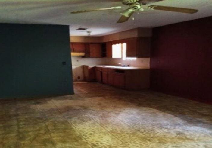 Kitchen with a ceiling fan and a sink