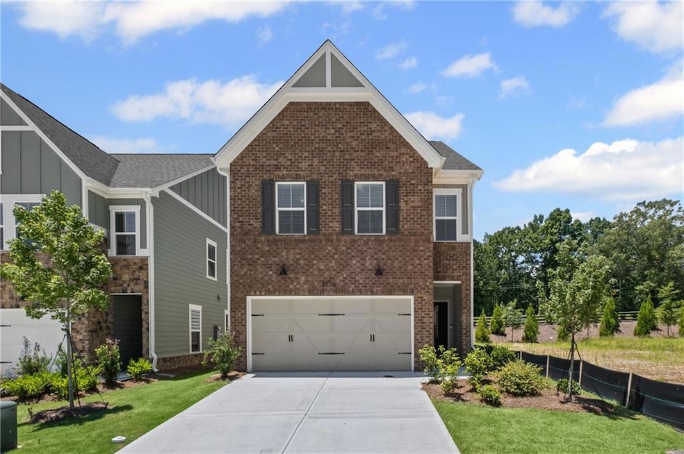 Craftsman house with a garage, concrete driveway, board and batten siding, and brick siding