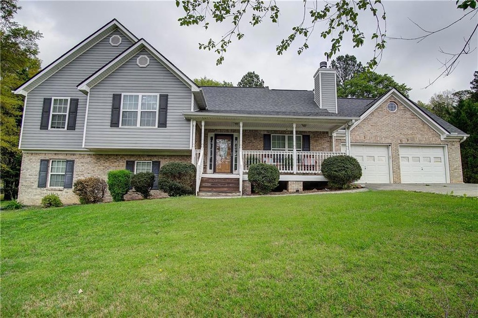 Split level home featuring covered porch, a front 