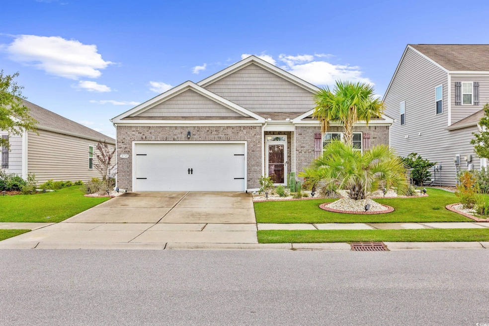 Craftsman house with a garage and a front lawn