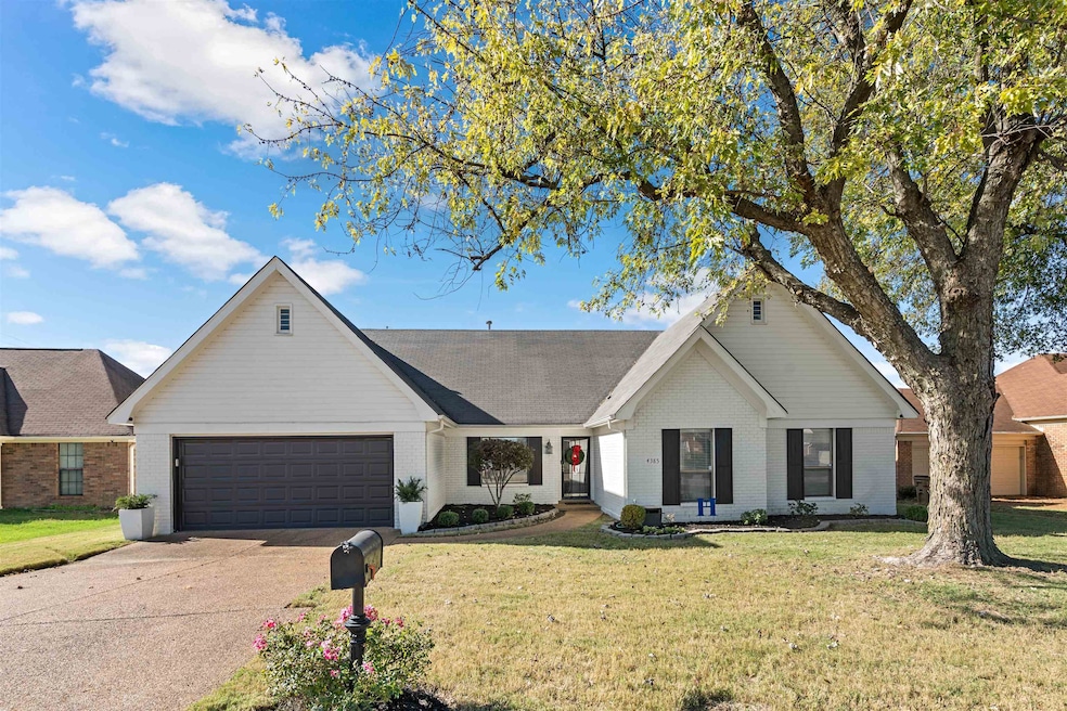 Single story home featuring a garage and a front y
