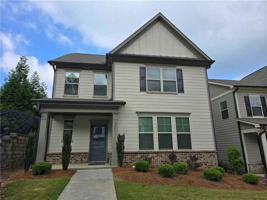 Craftsman-style house featuring brick siding, board and batten siding, and a porch