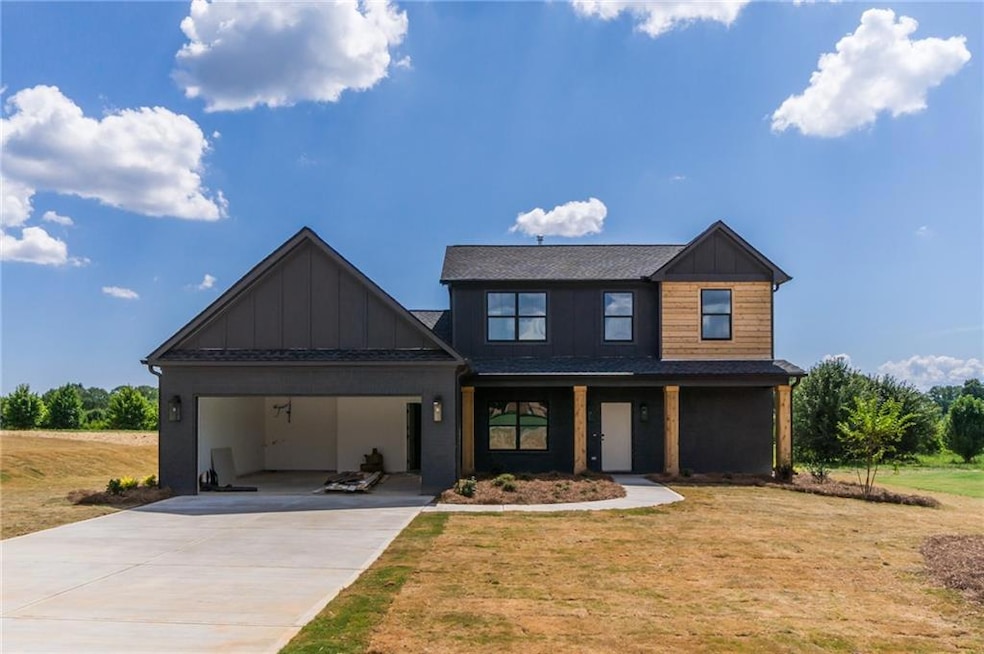 View of front of house with a garage and a front lawn