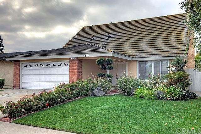 Perfect curb appeal with green lawn and flowering 