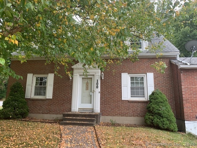 Stately brick cape cod style front entry.
